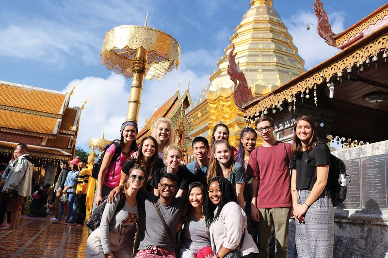group posed in front of temple in Chiang Mai