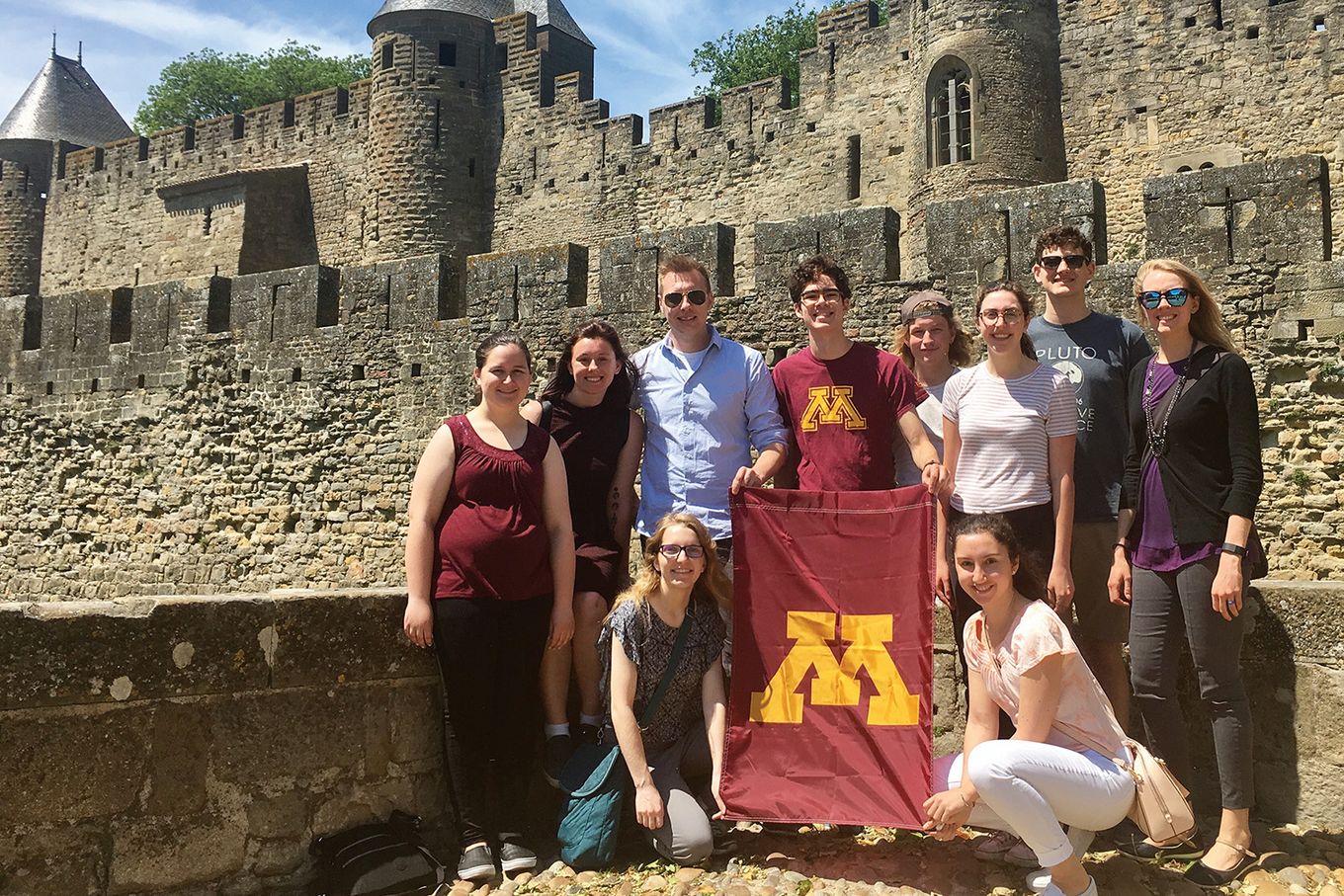 A group of UofM students with flag in Montpellier