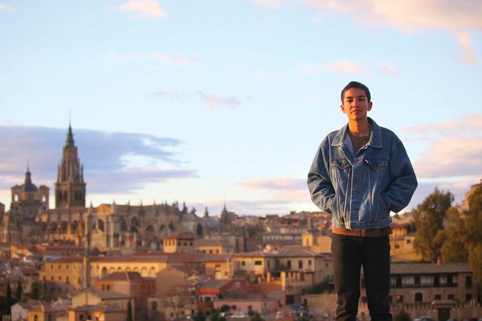 student in front of Toledo skyline
