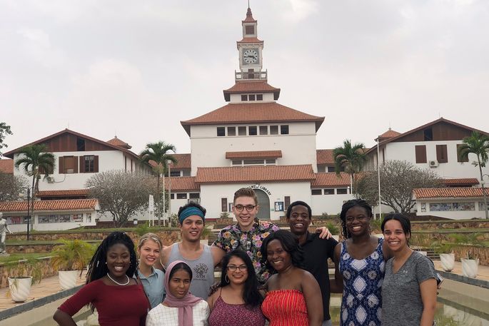 students posed in front of building in Ghana