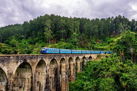 blue train on a bridge