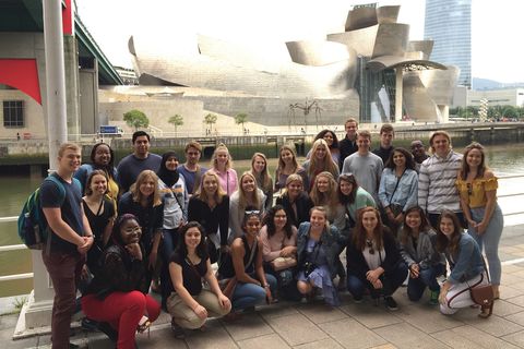 students posed in front of the Guggenheim Museum Bilbao