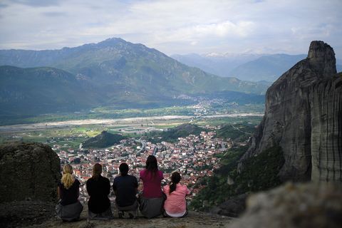 Students overlooking a Greek town from the mountains